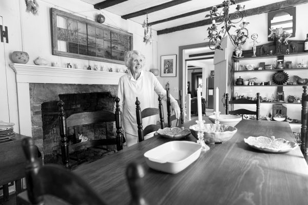 Woman standing in dining room.