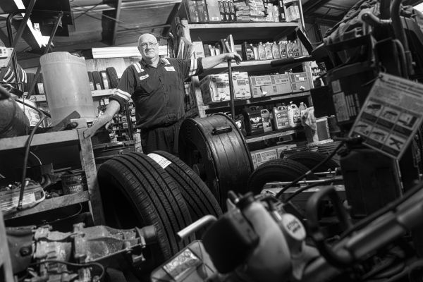 Man standing in mechanic shop.
